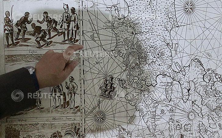 A shadow of Filipino businessman Mel Velarde is cast upon a replica of a 1734 map he bought at an auction in London, which shows the Scarborough Shoal as part of the Philippine territory under Spanish rule during a Reuters interview in Manila June 19, 2015. A nearly 300-year-old map of the Philippines showing islands in disputed waters hopes to boost the country's claim in the South China Sea, Velarde said on Tuesday. The map, published in 1734 by Spanish priest Pedro Murillo Veralde, showed Scarborough Shoal, located around 124 nautical miles from the island of Luzon and labeled as "Panacot" in the map , as part of the Philippines territory. The original map was still in London for safekeeping, but a certified true copy was submitted to the Philippine government when it requested copies of historical maps for its UN arbitration case against China in The Hague.   REUTERS/Romeo Ranoco